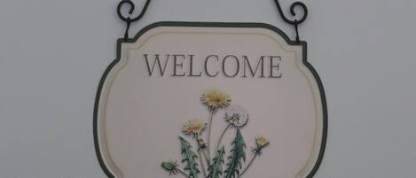 A welcome sign with a floral design.