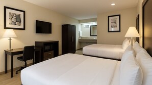 A hotel room with two beds, a desk, a TV, and a kitchenette. - Quality Inn Escondido San Diego North County (Escondido)