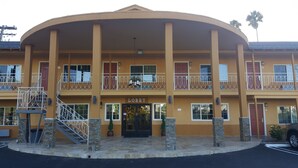 A two-story building with a curved facade, a central entrance labeled "Lobby," and a staircase leading to the upper level.