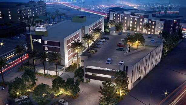 A hotel with a modern design, featuring a parking lot, multiple floors, and a prominent sign for TownePlace Suites by Marriott. - Home2 Suites by Hilton Las Vegas Stadium District (Las Vegas)