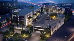 A hotel with a modern design, featuring a parking lot, multiple floors, and a prominent sign for TownePlace Suites by Marriott. - Home2 Suites by Hilton Las Vegas Stadium District (Las Vegas)