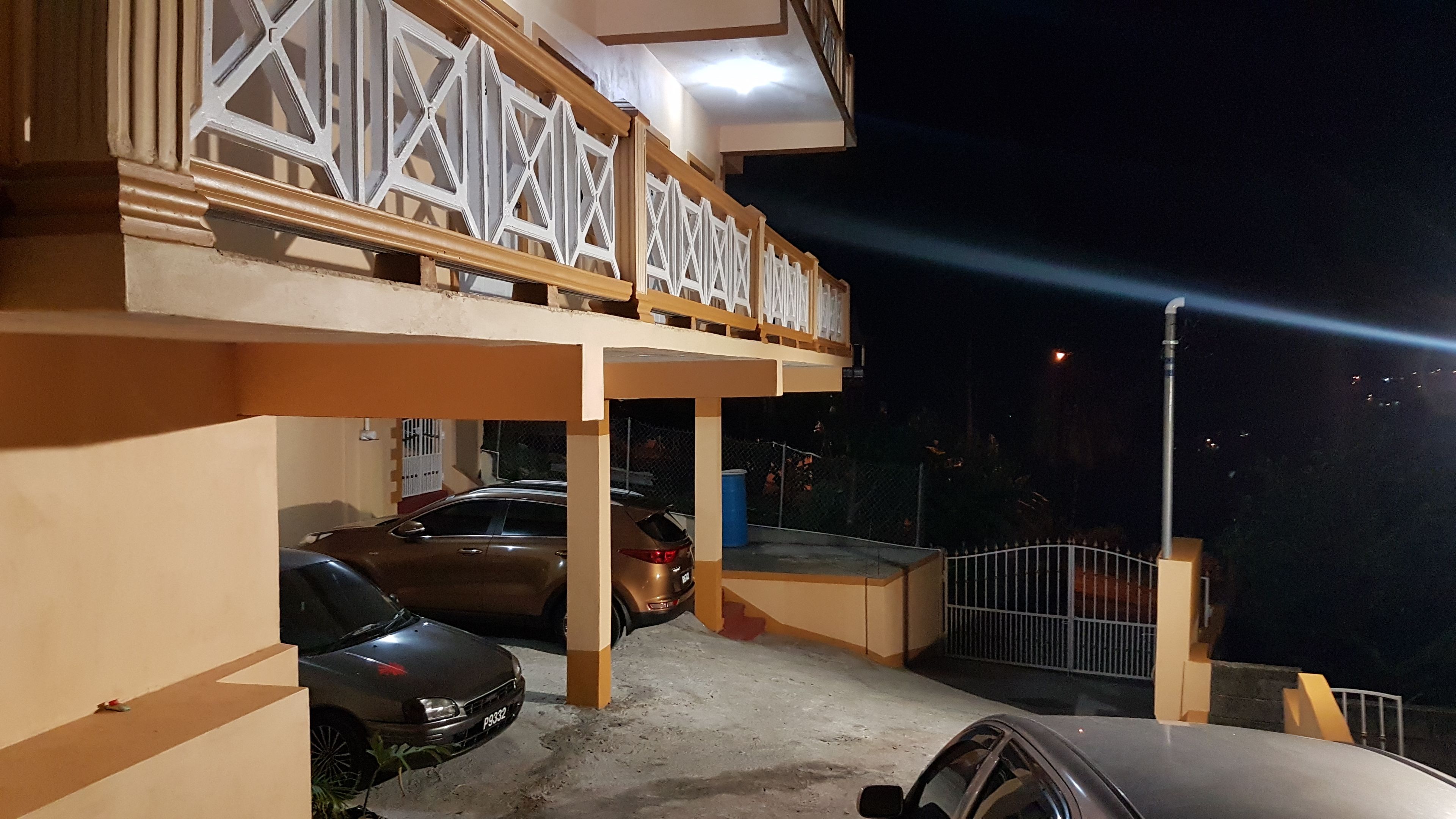 A two-story building with a covered parking area.
