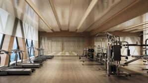 A modern gym with treadmills, elliptical machines, and weightlifting equipment. - Zhenjiang Marriott Hotel (Zhenjiang)