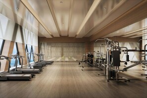 A modern gym with treadmills, elliptical machines, and weightlifting equipment. - Zhenjiang Marriott Hotel (Zhenjiang)