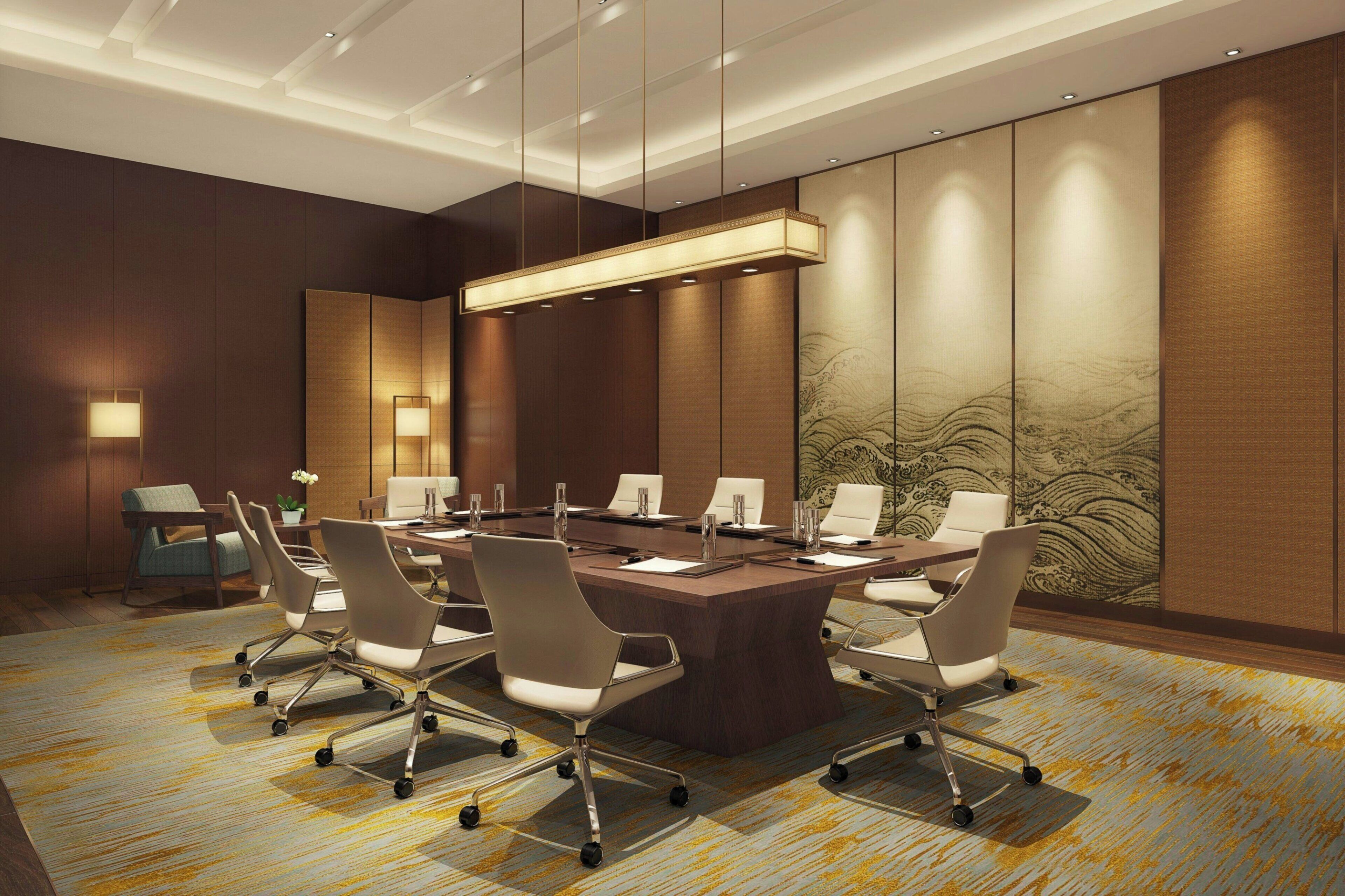 A conference room with a large table, chairs, and a modern chandelier.