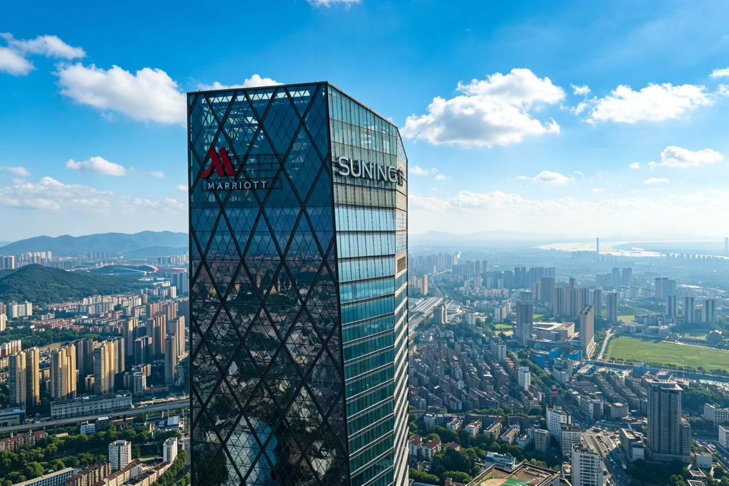 A high-rise hotel with a distinctive geometric facade and the Marriott logo.
