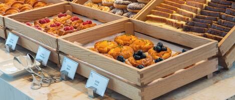 A bakery display with various pastries and baked goods.