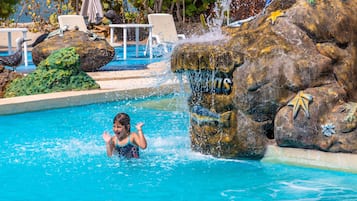 Relax by the pool surrounded by natural rock formations and a soothing waterfall.