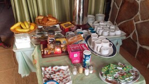 A buffet table with various food items, including pastries, fruits, and condiments. - Hotel Raha (Nouakchott)