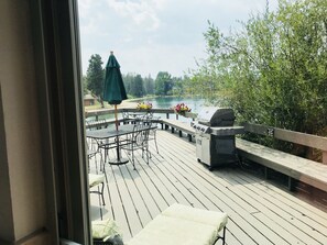 A deck with a grill, outdoor furniture, and a view of a lake. - Ski mountain & Lake Views -Resort Shuttle, Keystone Convention Center - 2 BR (Keystone)
