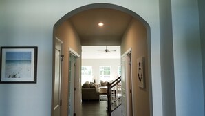 A hallway with an arched ceiling, a ceiling fan, and a framed picture on the wall. - Spacious Clean New House back to woods - just 1.5 miles away from Bethany beach (Ocean View)