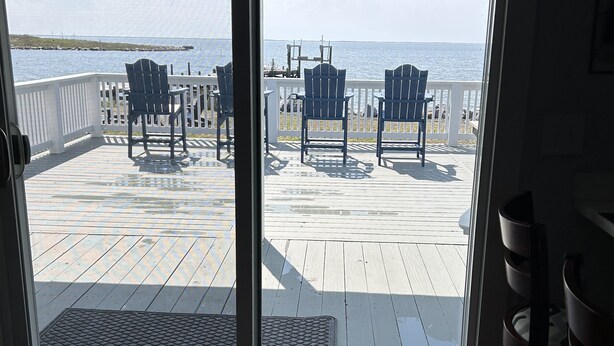 A view from a room with a sliding glass door to a deck with chairs and a table, overlooking a body of water. - Soundfront home
3 Bedrooms
3 Bathrooms (Atlantic)