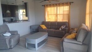 A living room with a sofa set, a coffee table, and a side table.