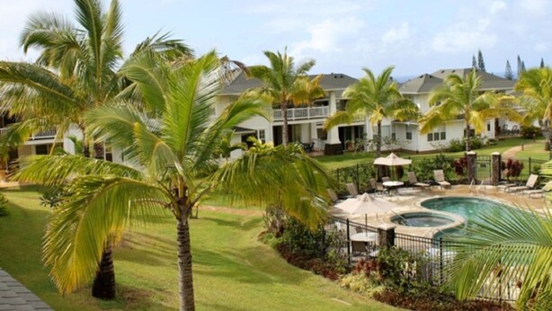 A resort with a pool area, palm trees, and a two-story building. - Gorgeous, 3 private suites. Balcony View, Pool, Fitness Center! (Princeville)