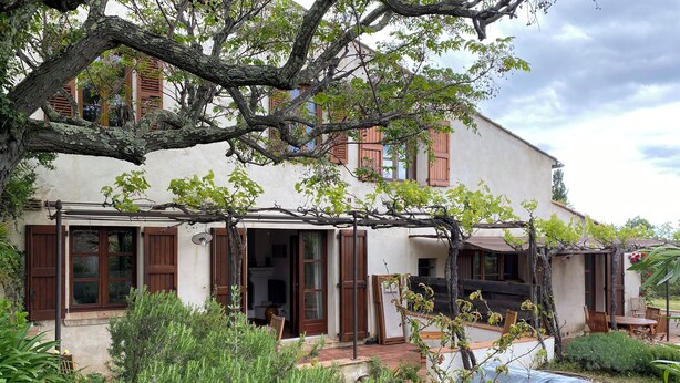 A two-story building with a covered patio, wooden shutters, and a garden area. - *** Les BOUTINELLES * Superb apartment in LA FERME DU MOULIN ROUX (Ramatuelle)