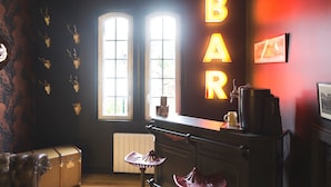A bar area with a vintage aesthetic, featuring skull decorations, a bar counter, and a radiator. - Charming Villa with Garden near the beach (Tourgéville)