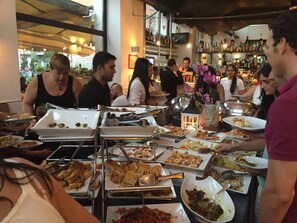 A buffet setup with various dishes and serving utensils. - Bright, comfortable and panoramic apartment! (Roma)