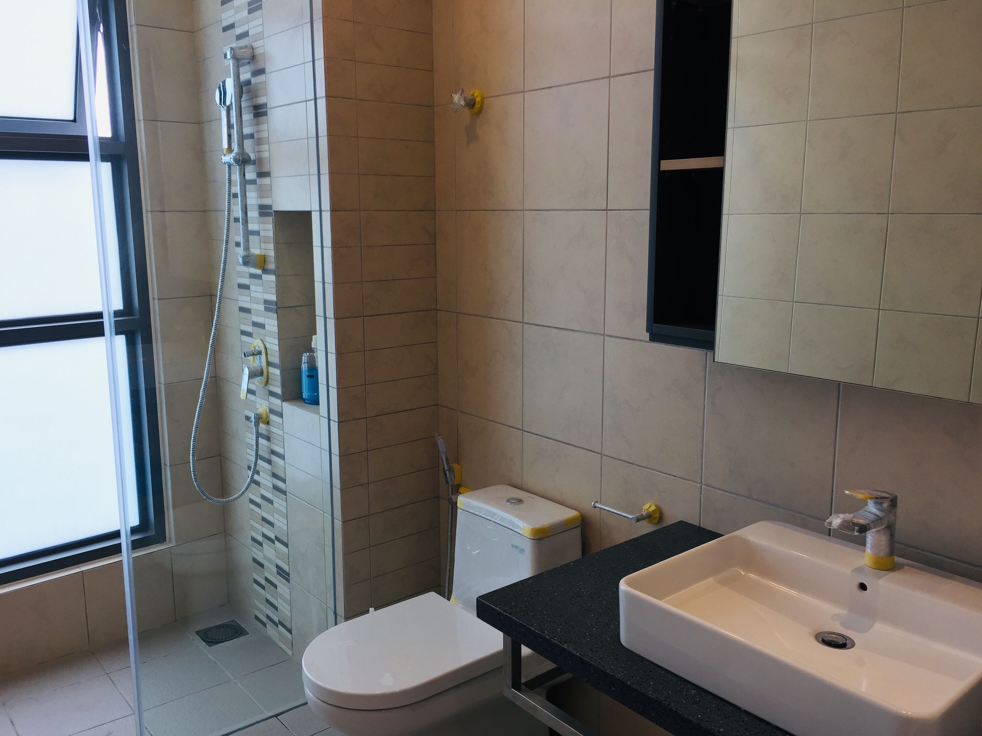A bathroom with a toilet, a sink, and a shower.