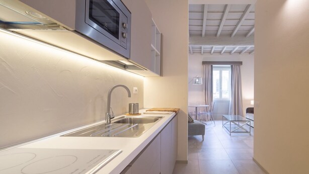 A modern kitchen with a stainless steel sink, a microwave, and a built-in oven. - Carapelli 4 Fabulous apartment for up to four guests (florence)