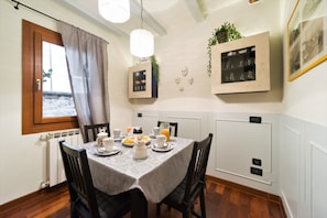 Enjoy a warm breakfast in this inviting dining area with a table set for a delicious meal.