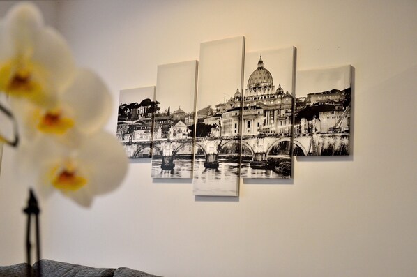 A wall with a black and white photograph of a bridge and buildings.