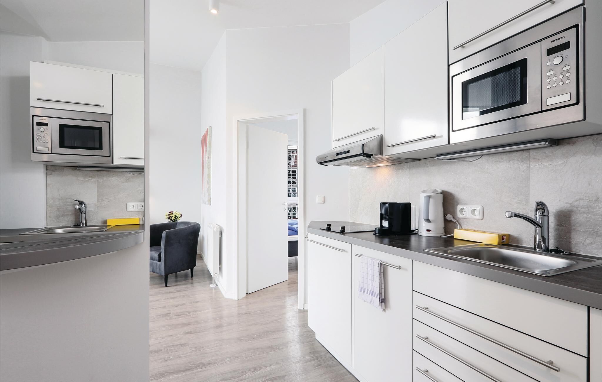 Fridge, stovetop, dishwasher, coffee/tea maker