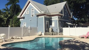 A two-story house with a swimming pool, bicycles, and a white fence. - Sun, beach, and unbeatable prices! (Fort Myers)