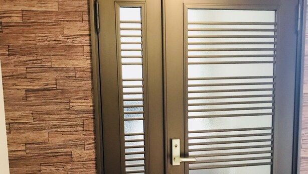A dark wooden door with a glass panel and a handle. - ONE Hostel&Standing Bar (Himeji)