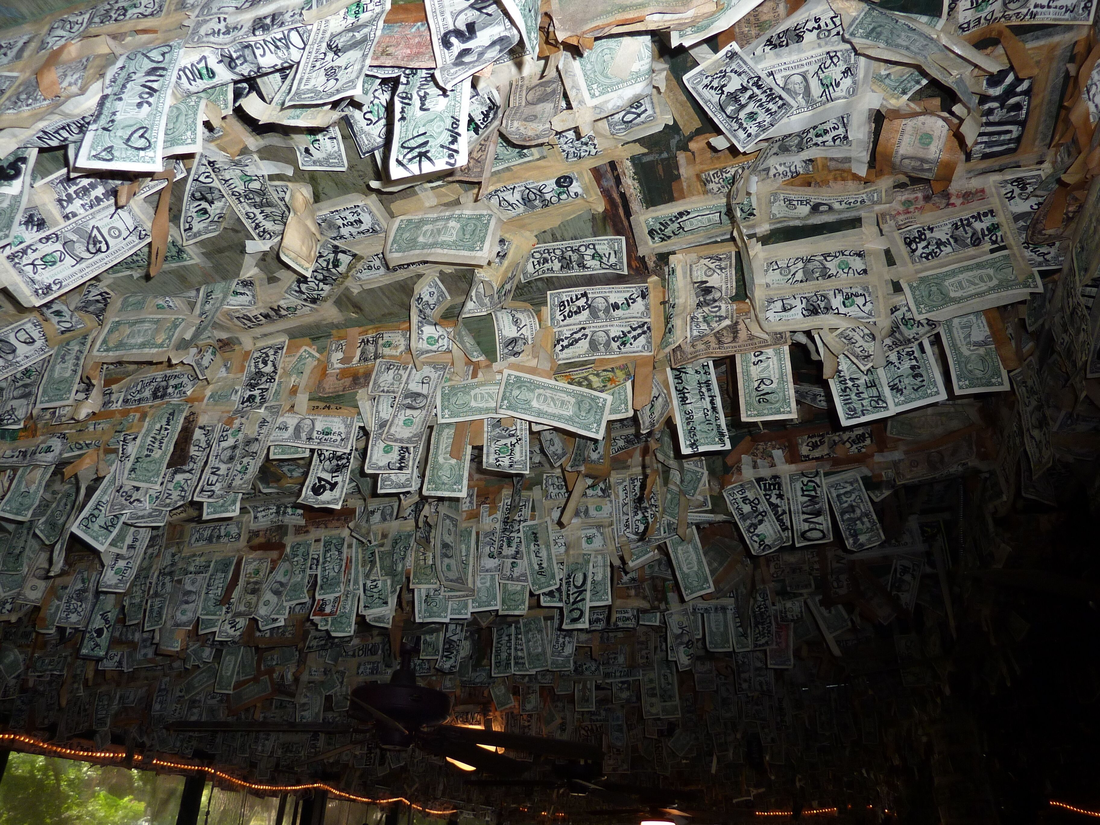 A room with walls covered in dollar bills.