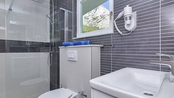 Shower, hair dryer, towels, soap