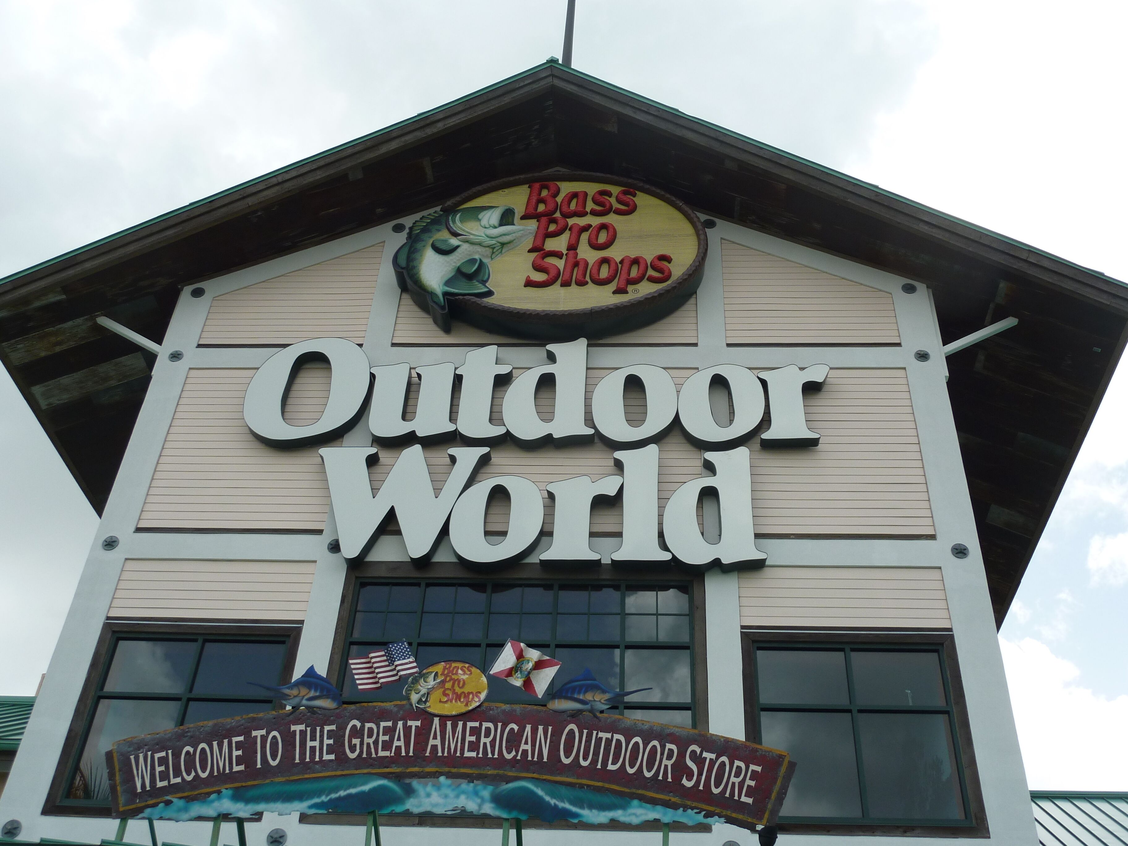 A building with a sign that reads "Bass Pro Shops" and "Outdoor World."