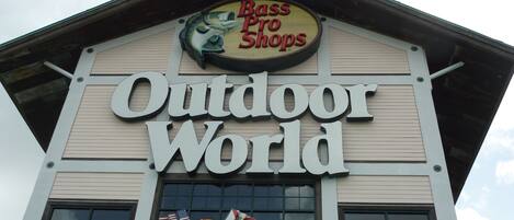 A building with a sign that reads "Bass Pro Shops" and "Outdoor World."