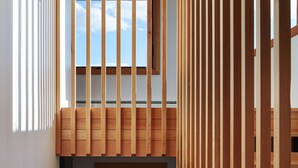 A modern interior with a wooden staircase, a small window, and a view of the sky. - The Aurora- Award Winning- Sauna available (Grand Marais)