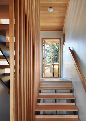 Staircase leads to an outdoor area with a natural view.