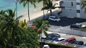 A high-rise building with a view of the ocean and palm trees. - GORGEOUS 2BD/2 BATH ON THE BEACH! DESIGNER APT.LUX! BEST LOCATION. (Cangrejo Arriba)