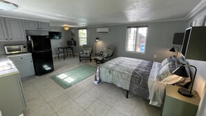 A compact room with a bed, a desk, a chair, a kitchenette, and a window. - Sun, beach, and unbeatable prices! (Matlacha)