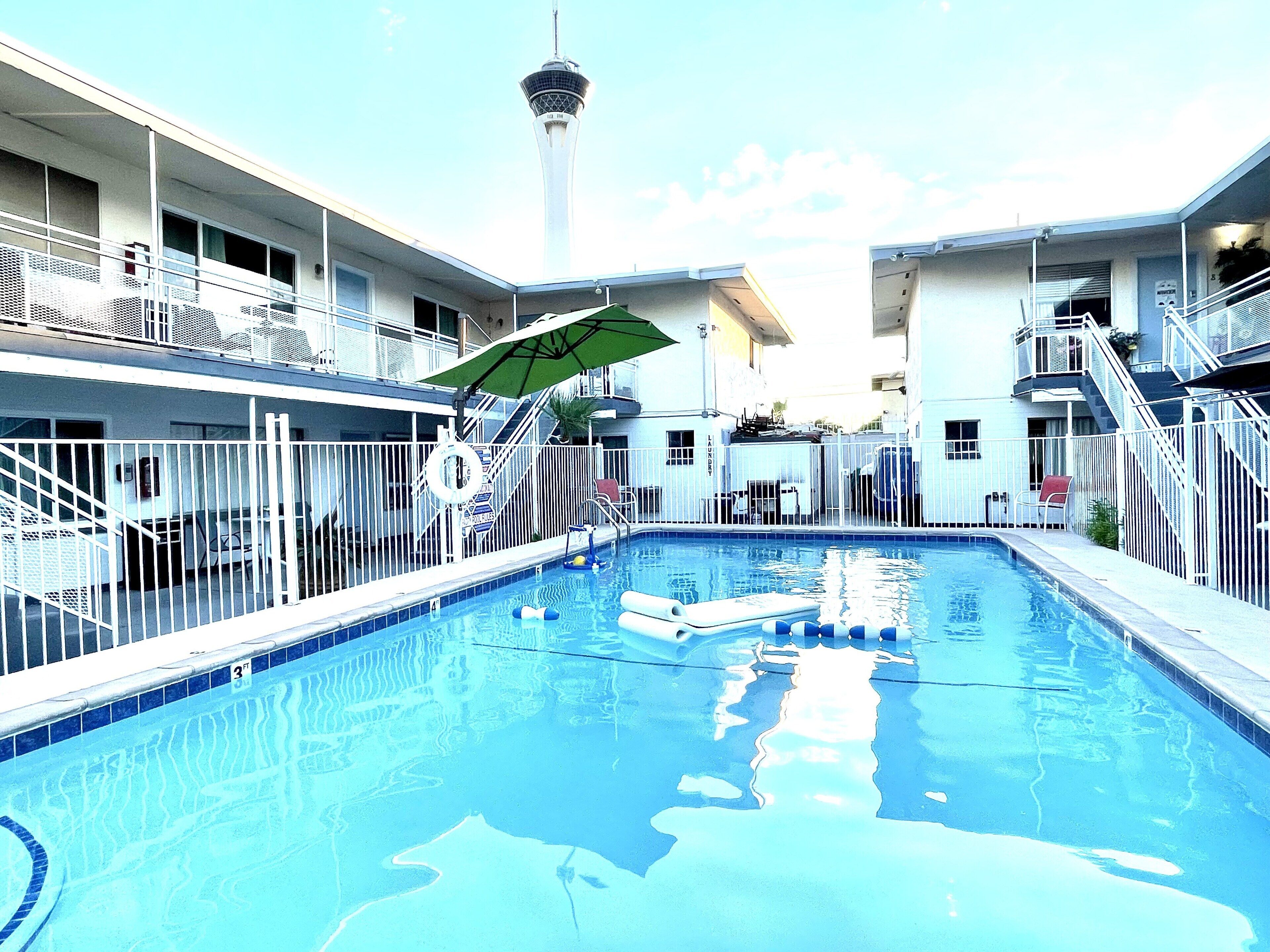 A swimming pool with a view of a tower in the background.