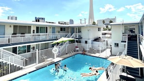 A hotel pool area with a view of a tall tower in the background. - 2BRpartment,LasVegas,Strip,Pet-friendly,Lvcc,SALE,BestSpot,Sema Show,Labor day (Las Vegas)