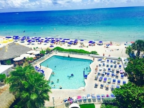 Relax by the pool or on the adjacent beach, surrounded by lush greenery and ocean views.