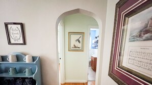 A hallway with a blue shelving unit containing mugs and containers labeled 'tea' and 'coffee'. - Make your visit to the beautiful city of Berea memorable! (Berea)