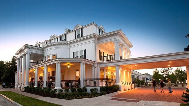 A large, white, two-story building with a covered entrance and columns. - Make your visit to the beautiful city of Berea memorable! (Berea)