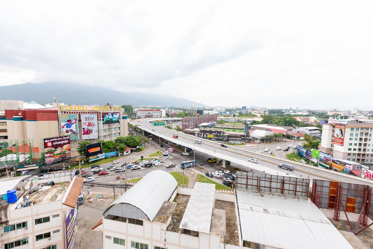 A cityscape with a prominent highway, commercial buildings, and billboards.