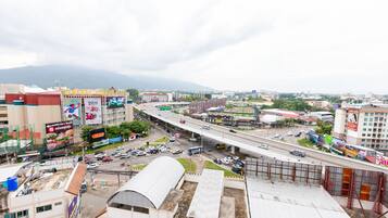 A cityscape with a prominent highway, commercial buildings, and billboards.
