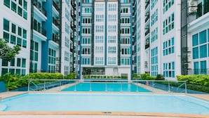 A modern building with a central swimming pool surrounded by balconies. - Locals ChiangMai Central Airport Plaza (Chiang Mai)
