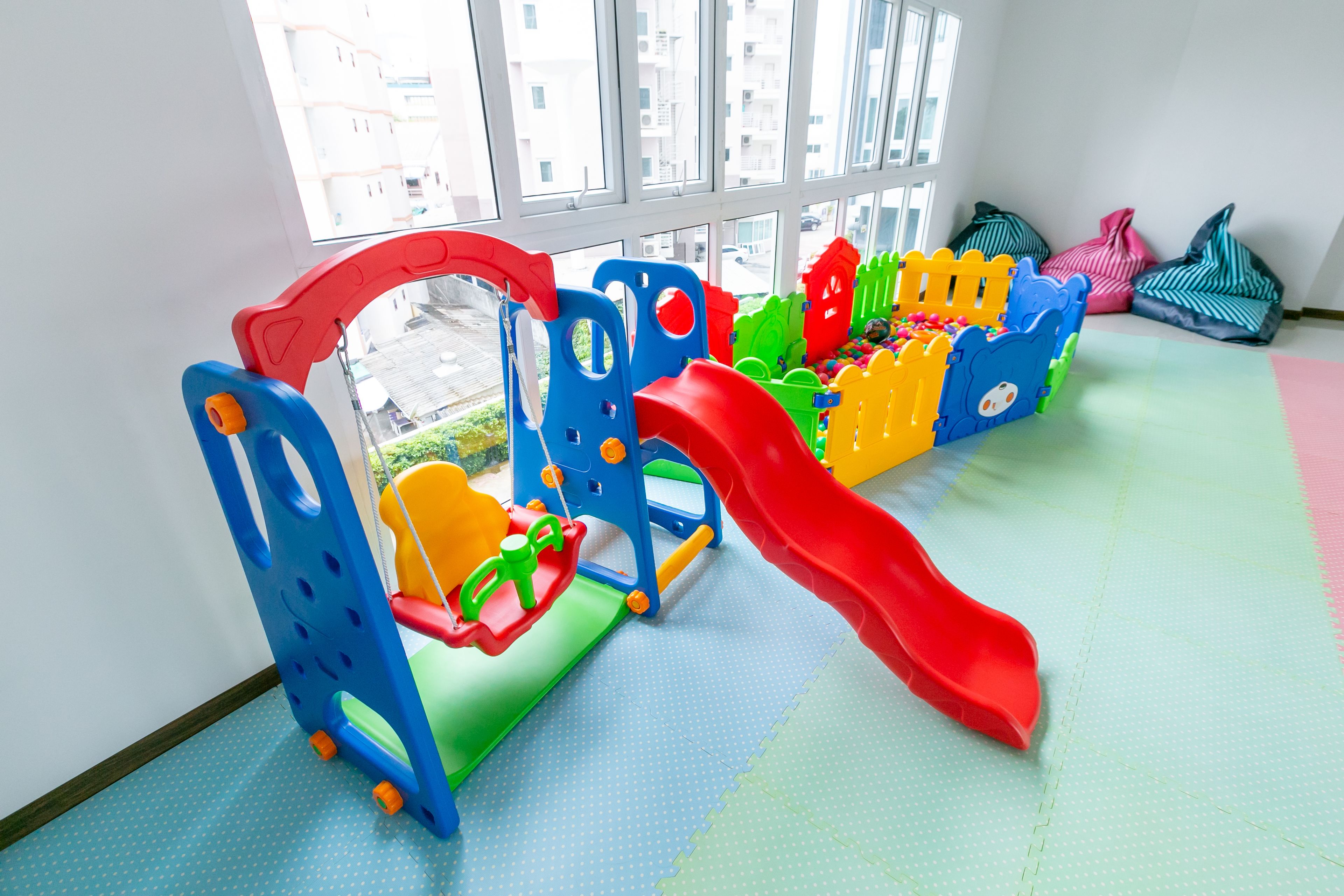 A children's play area with a slide and climbing structures.