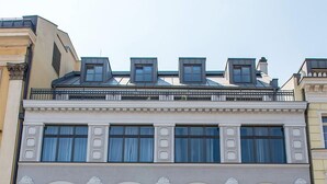 A multi-story building with a classic architectural style, featuring large windows and a prominent entrance. - Kamienica Pod Aniolami (Wroclaw)