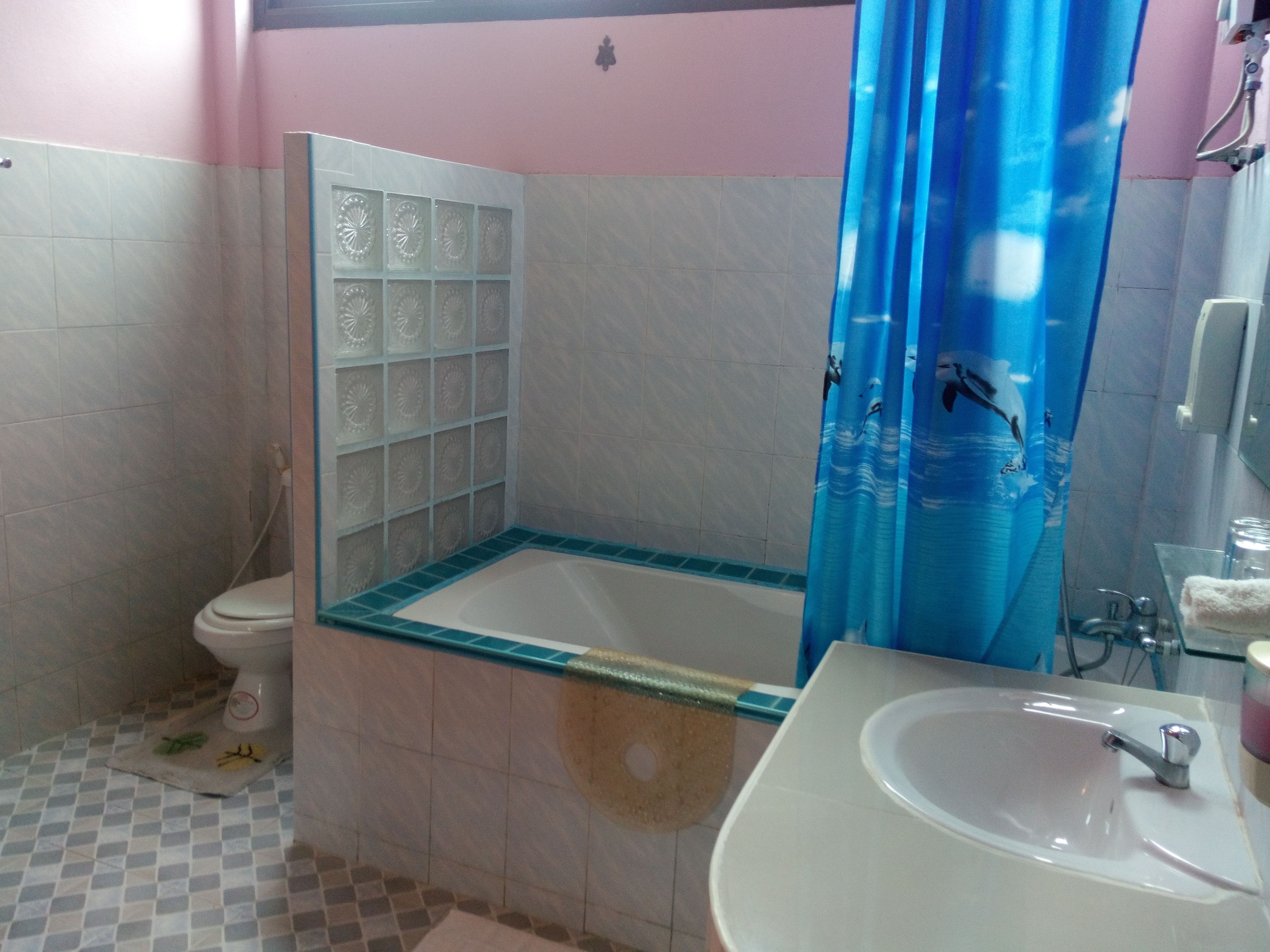 Un baño con bañera, inodoro y lavamanos.
