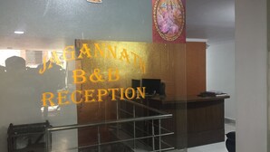 A reception area with a glass partition displaying 'JAGANNATH B&B RECEPTION'. - Jagannath B&B Hotel (New Delhi)
