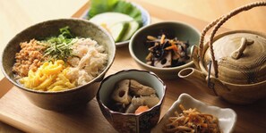A wooden table with various bowls containing different food items, a ceramic teapot, and a small decorative bowl. - HOTEL SUI KANDA byABEST (Tokyo)