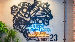 A wall with a neon sign for TOKYO ASAKUSABASHI 23, surrounded by abstract black metal art pieces. - ICI HOTEL Asakusabashi (Tokyo)